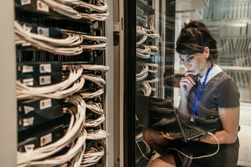 female IT employee working in server room