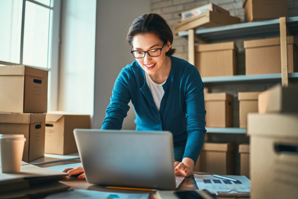 Woman is working at warehouse for online store.