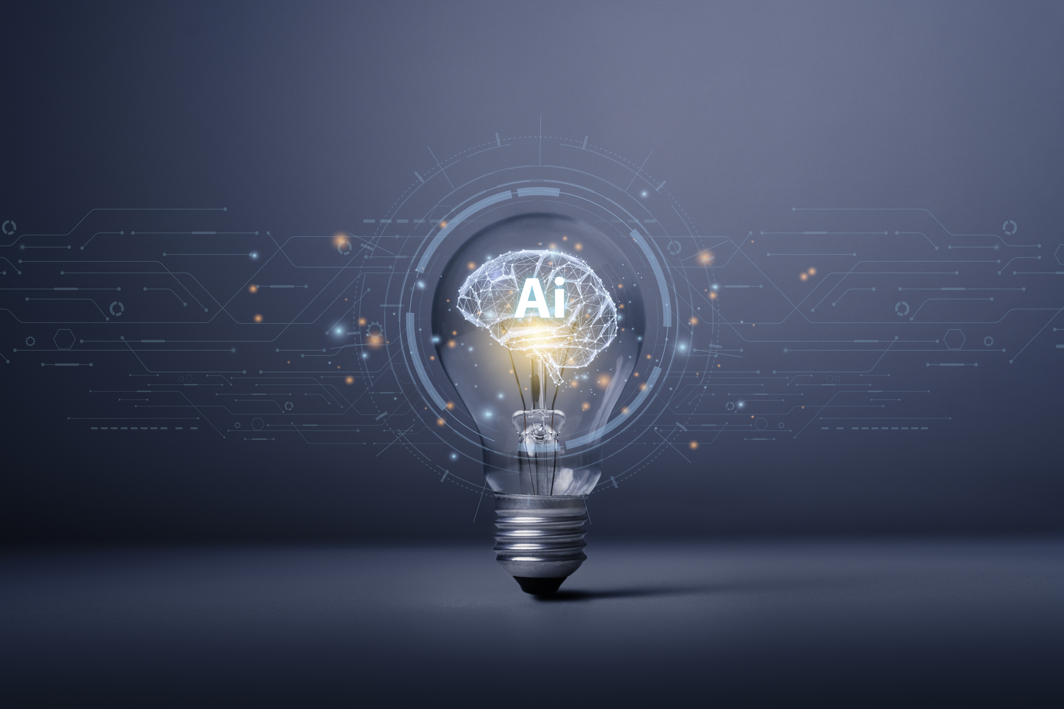 Brain with AI written on it inside a light bulb